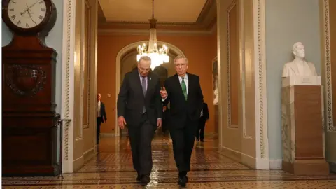 Getty Images Senate Minority Leader Charles Schumer (D-NY) (L) and Senate Majority Leader Mitch McConnell (R-KY) walk side-by-side to the Senate Chamber at the U.S. Capitol February 7, 2018