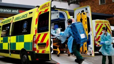 Getty Images A patient is taken from an ambulance at Guy's Hospital in central London on Tuesday