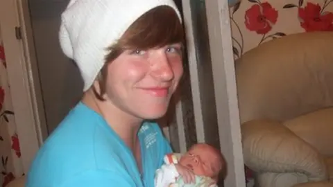 Dylan Ramsay, holding his baby nephew