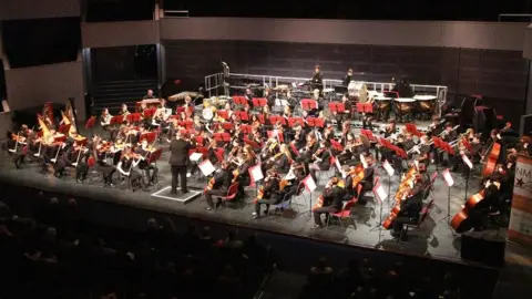 NMPAT Large orchestra made up of young players on stage at the Derngate theatre