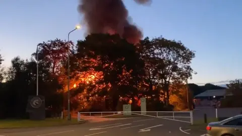 David Flood Huge plume of smoke coming from fire at a garden centre