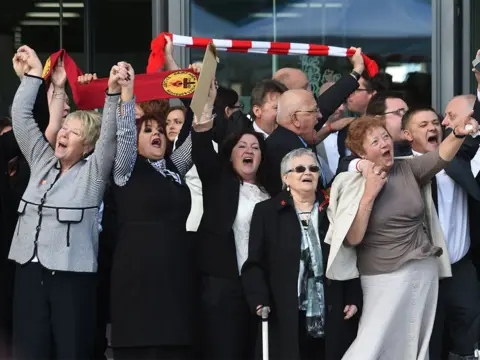 PA Media Family members affected by the 1989 Hillsborough disaster, Warrington, 2016