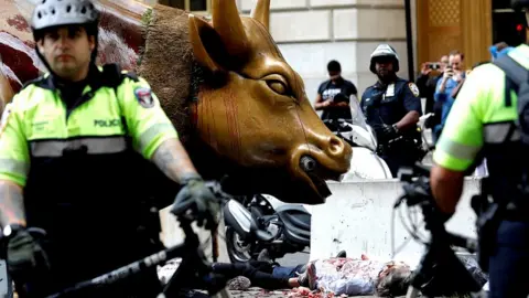 Reuters Climate change activists are surrounded by police as they protest at the Wall Street Bull in Lower Manhattan during Extinction Rebellion protests in New York City, October 7, 2019