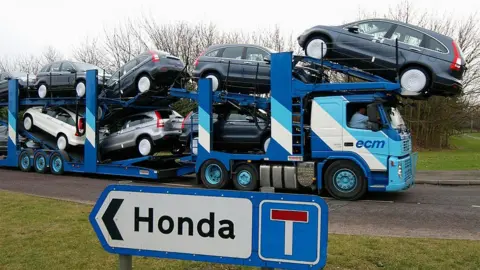 Max Nash/ Getty Images A transporter loaded with Honda cars leaves the Honda car factory in Swindon