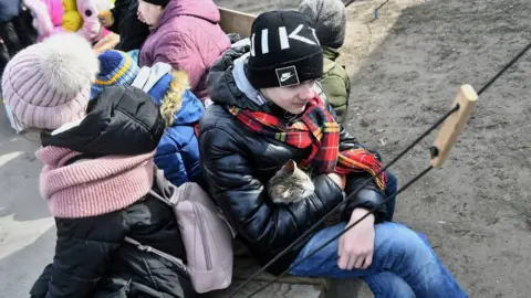 ANDRZEJ LANGE/European Pressphoto Agency Ukrainian refugees wait for a train at the railway station in Lviv, western Ukraine