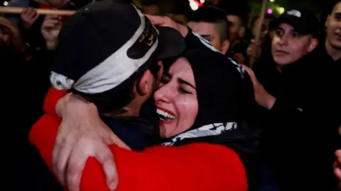 Reuters A Palestinian mother cries as she hugs her returned son