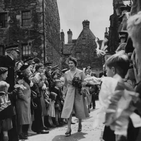 Getty Images 12th July 1952: Queen Elizabeth on a visit to the Scottish Craft Centre, Edinburgh. The royal visit was the first by a reigning monarch in 50 years and also the first time Queen Elizabeth had stayed at the Palace.