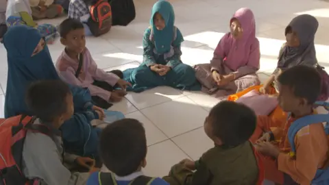 Lulu, far left, with her schoolchildren