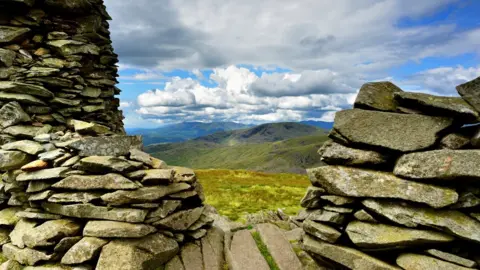 Getty Images A stone cairn with hills beyond