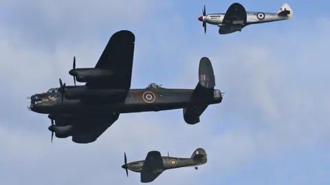 PA Media A Hurricane, Spitfire and Lancaster Bomber from the Battle of Britain Memorial Flight in the air at the air show