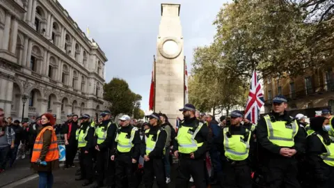 Reuters Met Police officers pictured by The Cenotaph in London