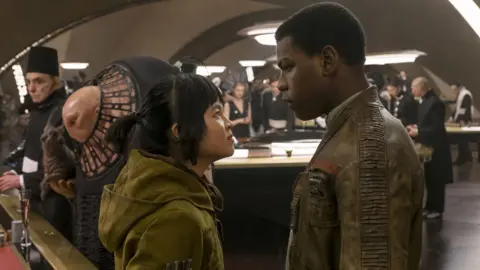 Disney/Lucasfilm Kelly Marie Tran with John Boyega in Star Wars: The Last Jedi