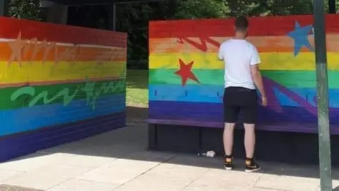 Mark Jones Artist repairing mural