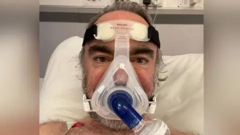 BBC Ian Cottrell being given help breathing