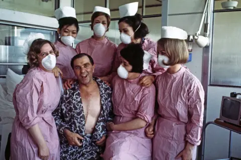 Getty Images Britain's first heart transplant patient Frederick West pictured with nurses after recovering from a heart transplant operation