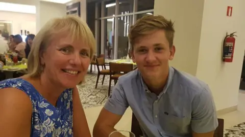 Stimpson Family A woman with blonde hair and a boy with brown hair