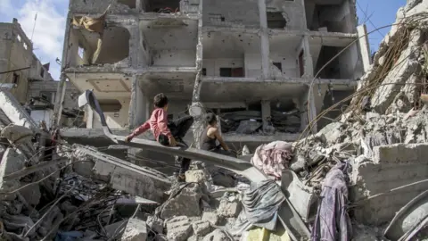 Getty Images Streets, roads, avenues in the northern Gaza city of Sheikh Zayed left in ruins