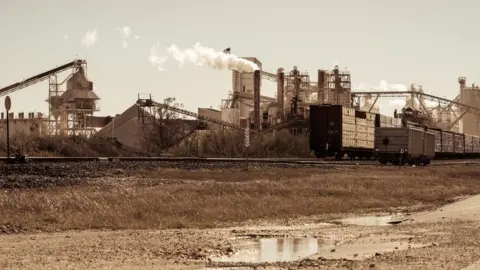 Getty Images Industrial revolution mining factory on railroad tracks - stock photo