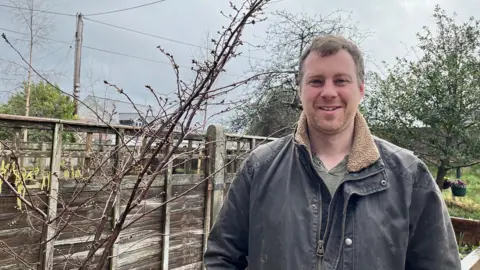 a man by a cherry tree