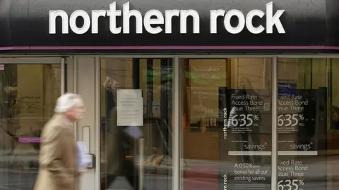 Getty Images Man walks past a Northern Rock branch