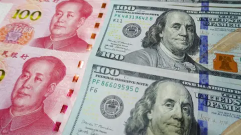 Getty Images US and Chinese bank notes.