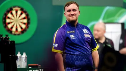 PA Media Luke Littler reacts after victory over Rob Cross (not pictured) on day fifteen of the Paddy Power World Darts Championship at Alexandra Palace,