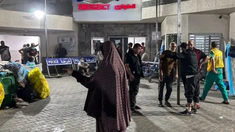 Getty Images People stand outside emergency ward at Al-Shifa - 10 November