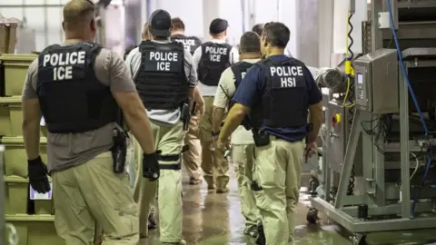 Reuters ICE agents at a raid in the US