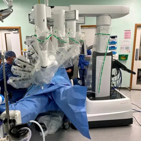 EPA The four-armed robot performed successful surgery on Deborah Speirs