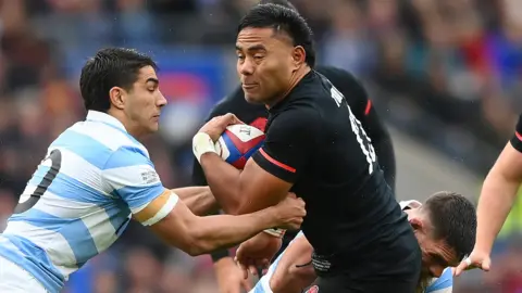 Argentina players stop England's Manu Tuilagi in his tracks