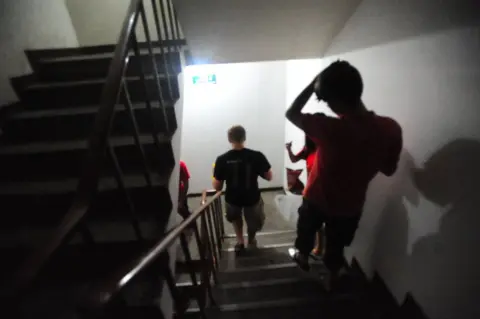 Calvin Sun Group walking down a stairwell