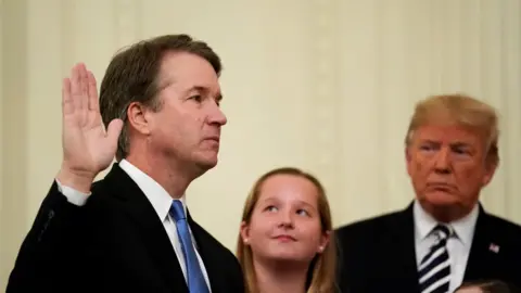 Reuters US Supreme Court Associate Justice Brett Kavanaugh is sworn in while his daughters and US President Donald Trump look on, 8 October 2018