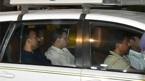 Getty Images : Delhi Chief Minister Arvind Kejriwal being arrested by ED following a raid on March 21, 2024 in New Delhi, India