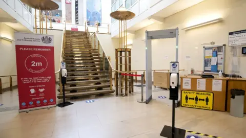 PA Media The entrance to a court