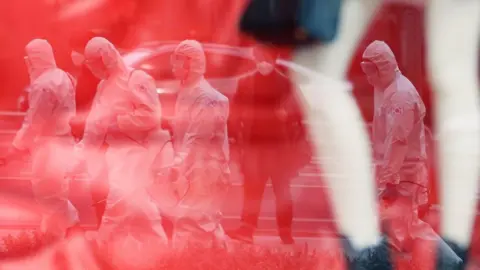 BBC Korea workers in protective suits and masks