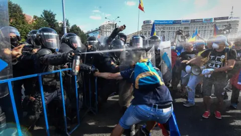 AFP/Getty Police use pepper spray on Romanian protesters