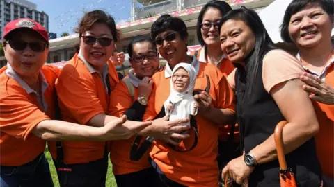 AFP Halimah Yacob supporters with a doll of her in Singapore (13 Sept)