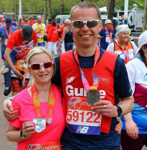 Kelly Barton with her guide Mike at the end of the London Marathon