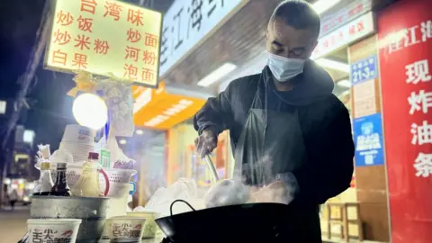Joyce Liu/BBC Man makes Taiwanese styled noodles