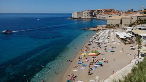 Reuters People enjoying time on a beach in Dubrovnik, Croatia