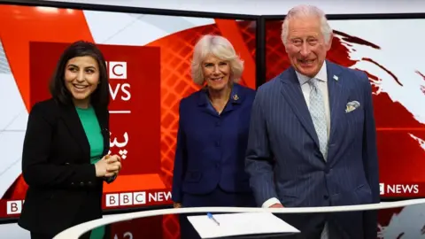 Reuters BBC's Sana Safi shows the prince and duchess round a studio