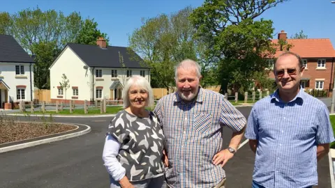 BBC Keith Jenkin (centre) his wife Lorna and friends decided to build social housing in Lyme Regis