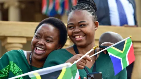Presidency of South Africa/Twitter Two supporters holding flags