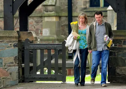 PA Media Kate and Gerry McCann leave church in Rothley, Leicestershire, after a service to mark the first anniversary of their daughter's disappearance