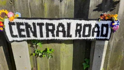 Doris Long-Kubas Crocheted Central Road sign