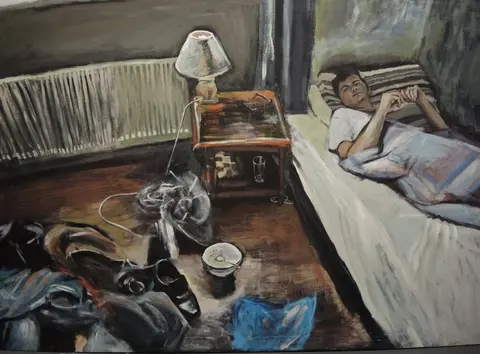 Robin Gage A boy lying in bed.