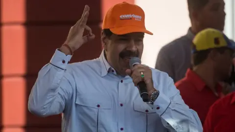 EPA President Maduro wearing a Conviasa hat