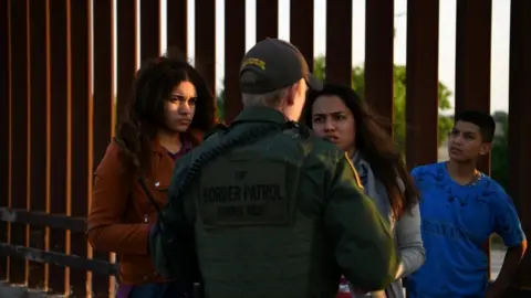 Reuters Migrants from Central America seeking asylum speak to a US official after crossing the Rio Grande river