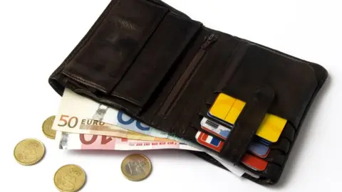 Getty Images Wallet with euro notes and coins