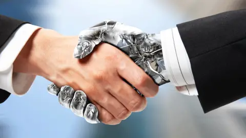 Getty Images Handshake between a human hand and a robotic one